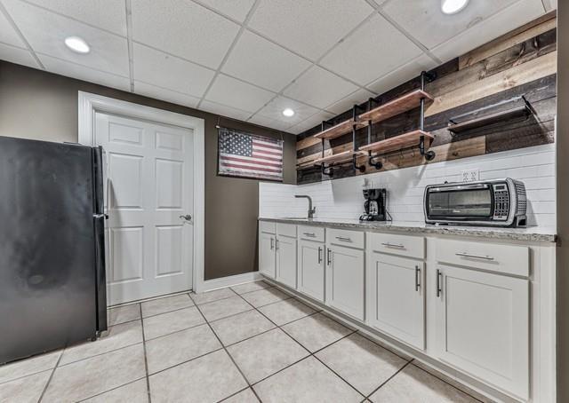 recreation room featuring light tile patterned floors, pool table, visible vents, wainscoting, and a raised ceiling