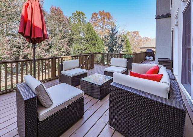 wooden terrace with an outdoor hangout area