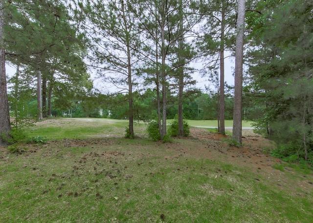 back of property with a yard, a chimney, a fenced backyard, stairway, and a wooden deck