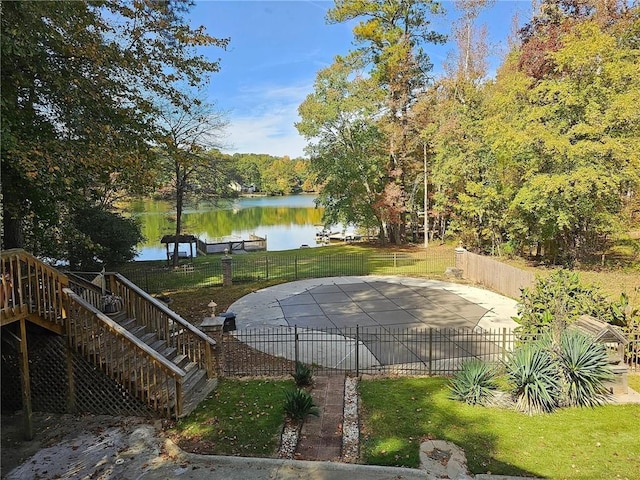 view of pool featuring a yard and a water view