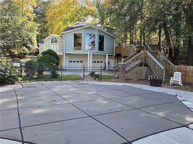 rear view of property with a garage