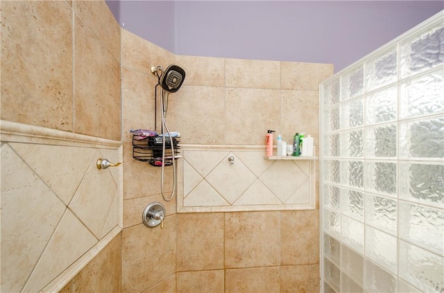 bathroom with a tile shower