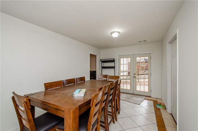 dining area with light tile patterned floors and french doors