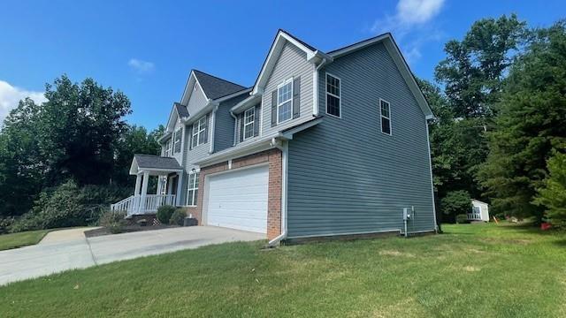 view of side of property with a garage and a yard