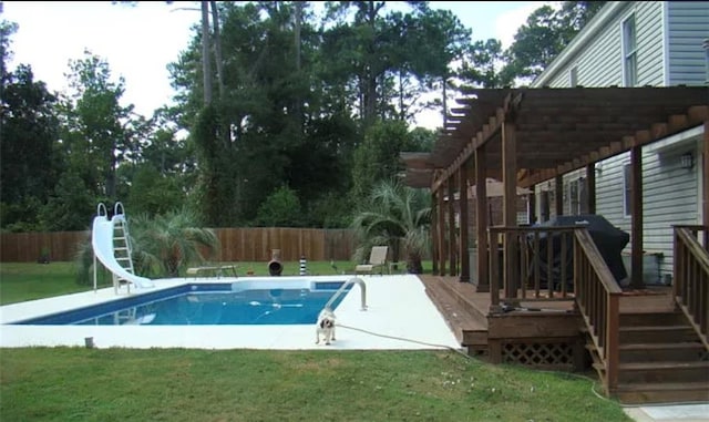 view of swimming pool featuring a water slide, a yard, a deck, and a pergola