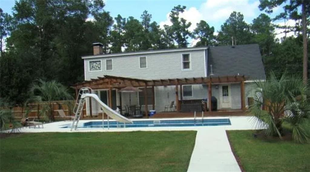 rear view of property with a patio area, a lawn, and a pergola