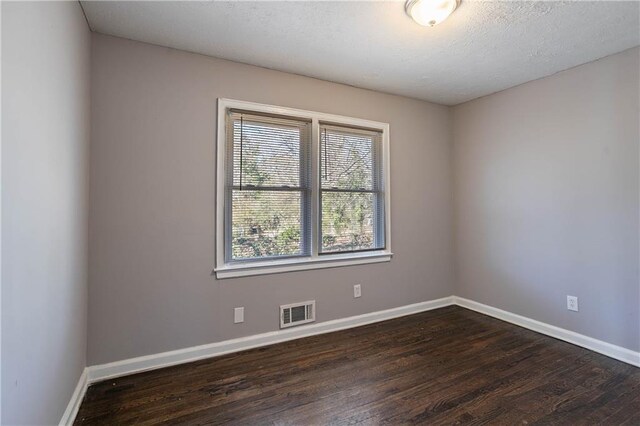 spare room featuring dark hardwood / wood-style floors