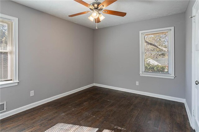 unfurnished room featuring ceiling fan and dark hardwood / wood-style floors