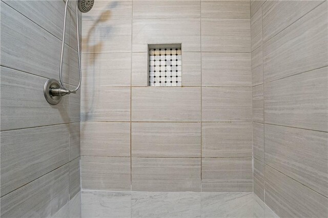 bathroom with a tile shower
