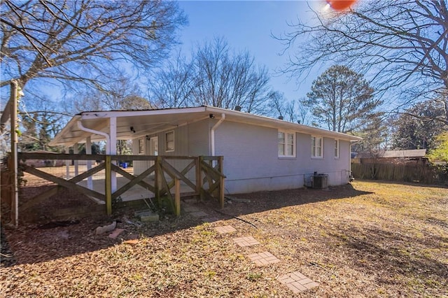 view of property exterior with cooling unit and a carport