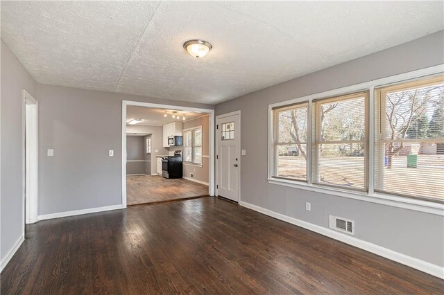 interior space with dark hardwood / wood-style floors and a textured ceiling