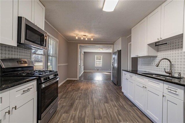 kitchen with sink, white cabinets, and stainless steel appliances