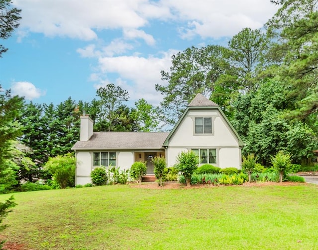 529 Arnold Rd, Lawrenceville, GA 30044 - view of front of house featuring a front lawn, a chimney, and stucco siding