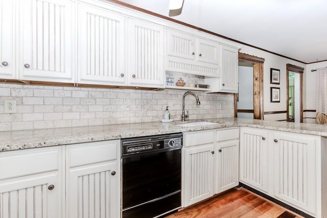 529 Arnold Rd, Lawrenceville, GA 30044 - kitchen featuring black dishwasher, a sink, decorative backsplash, light wood-style flooring, and white cabinetry