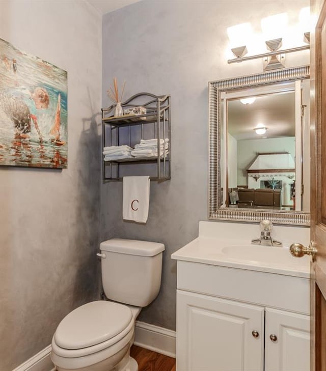 529 Arnold Rd, Lawrenceville, GA 30044 - bathroom with toilet, baseboards, vanity, and wood finished floors
