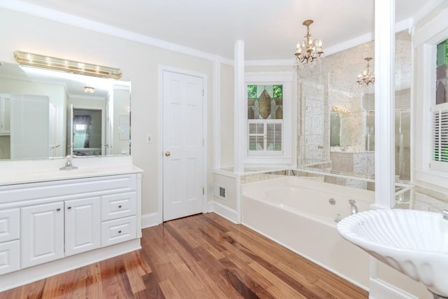 529 Arnold Rd, Lawrenceville, GA 30044 - bathroom featuring a chandelier, a bath, wood finished floors, and vanity