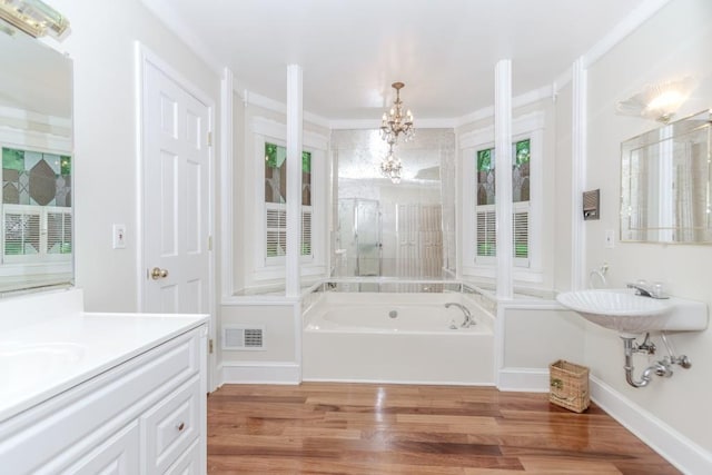 529 Arnold Rd, Lawrenceville, GA 30044 - bathroom featuring wood finished floors, a chandelier, and a bath