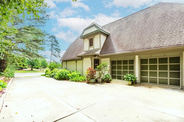 529 Arnold Rd, Lawrenceville, GA 30044 - view of front facade with stucco siding, a shingled roof, driveway, and a garage