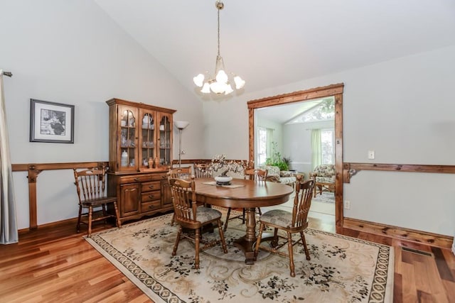 529 Arnold Rd, Lawrenceville, GA 30044 - dining area featuring a chandelier, light wood-type flooring, high vaulted ceiling, and baseboards