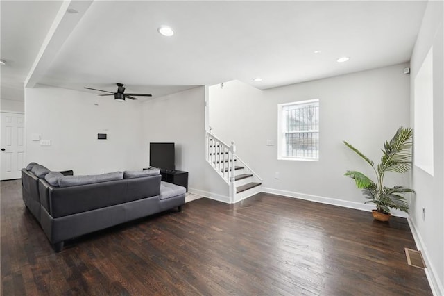 living room featuring dark hardwood / wood-style floors and ceiling fan