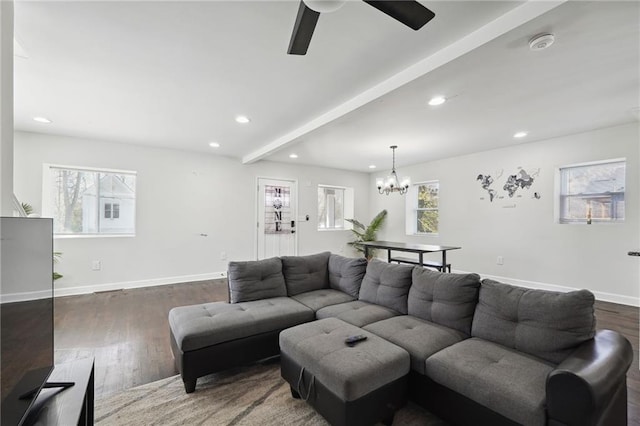 living room featuring beamed ceiling, ceiling fan with notable chandelier, and dark wood-type flooring