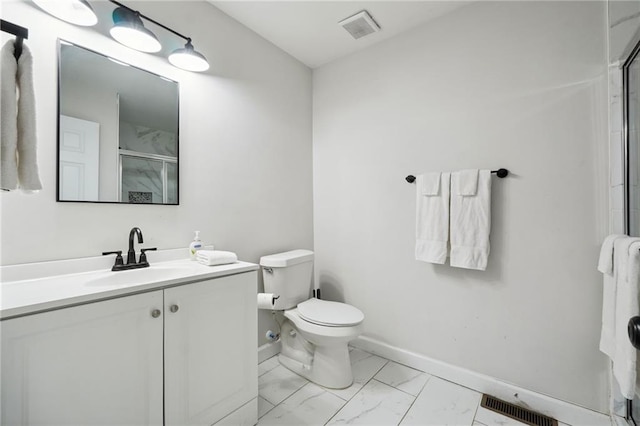 bathroom featuring an enclosed shower, vanity, and toilet