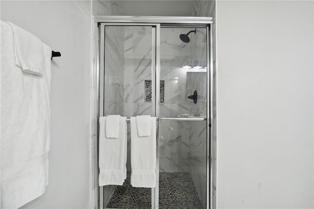 bathroom with a shower with shower door