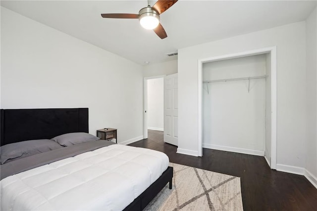 bedroom with a closet, ceiling fan, and dark hardwood / wood-style flooring