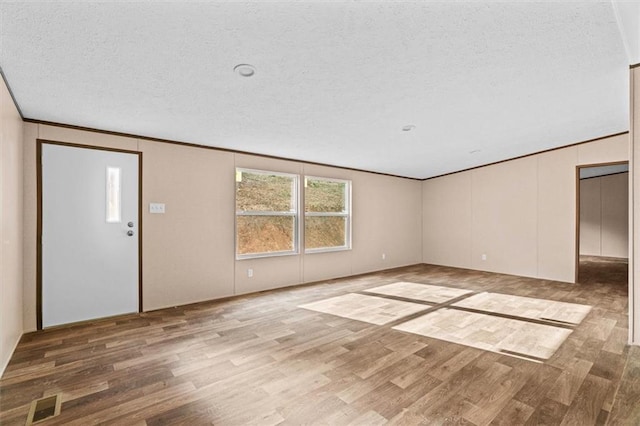 211 Fire Tower Rd NE, Calhoun, GA 30701 - foyer with wood finished floors, a textured ceiling, and crown molding