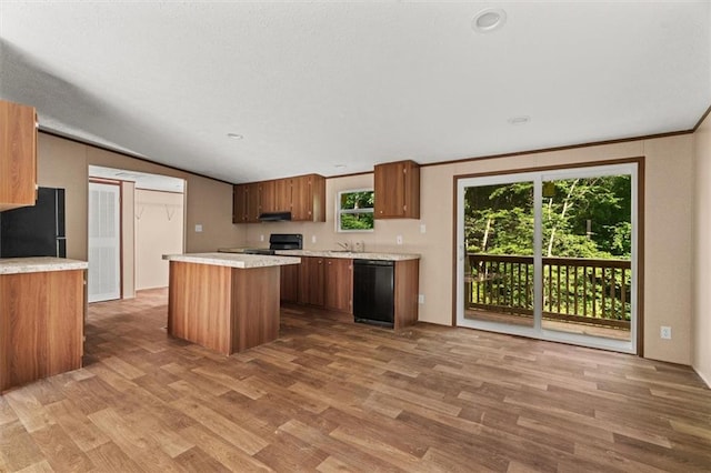 211 Fire Tower Rd NE, Calhoun, GA 30701 - kitchen featuring black dishwasher, freestanding refrigerator, range, wood finished floors, and a center island