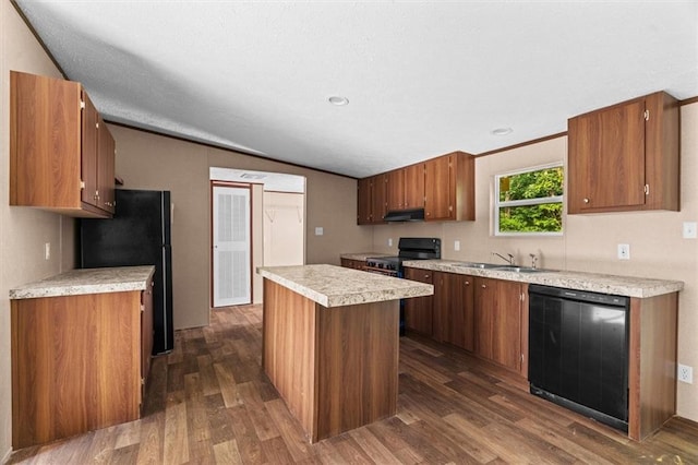211 Fire Tower Rd NE, Calhoun, GA 30701 - kitchen featuring black appliances, a sink, light countertops, a kitchen island, and dark wood-type flooring