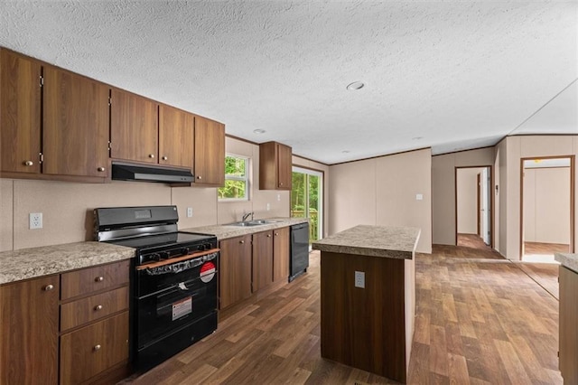 211 Fire Tower Rd NE, Calhoun, GA 30701 - kitchen featuring black appliances, under cabinet range hood, a sink, a textured ceiling, and dark wood finished floors