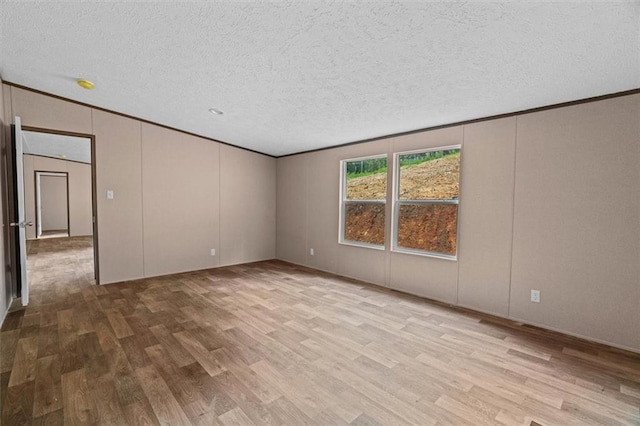 211 Fire Tower Rd NE, Calhoun, GA 30701 - spare room featuring wood finished floors, ornamental molding, a textured ceiling, and a decorative wall