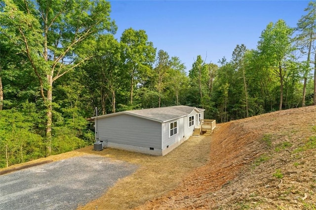 211 Fire Tower Rd NE, Calhoun, GA 30701 - view of property exterior with crawl space, driveway, and a view of trees