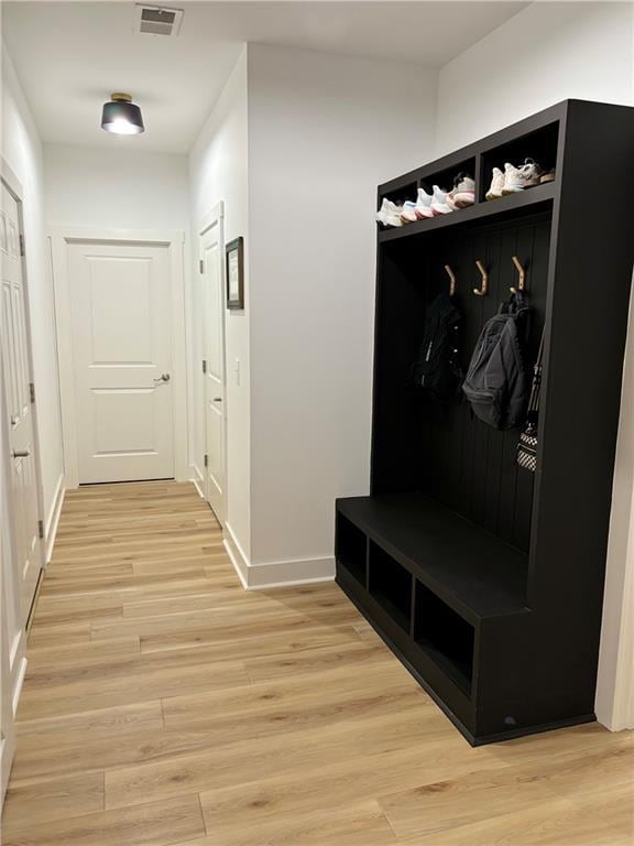 mudroom with light hardwood / wood-style flooring