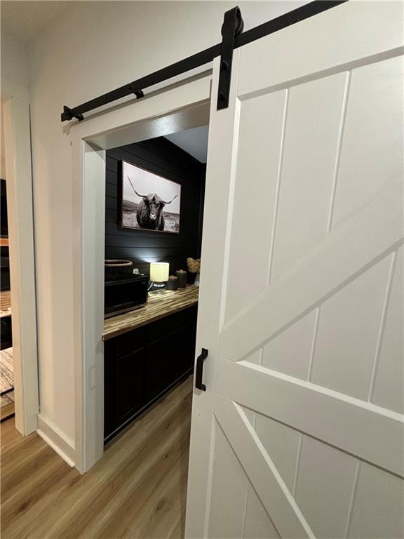 interior space with hardwood / wood-style flooring and a barn door