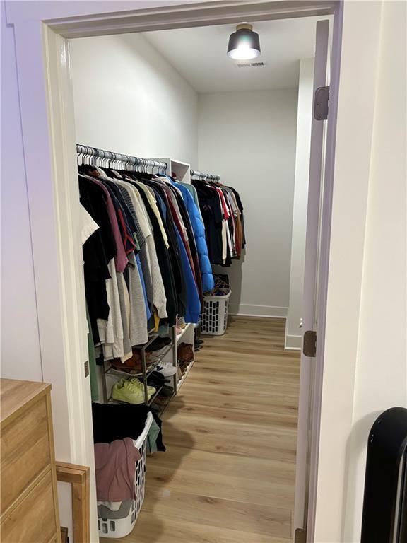 walk in closet featuring hardwood / wood-style flooring