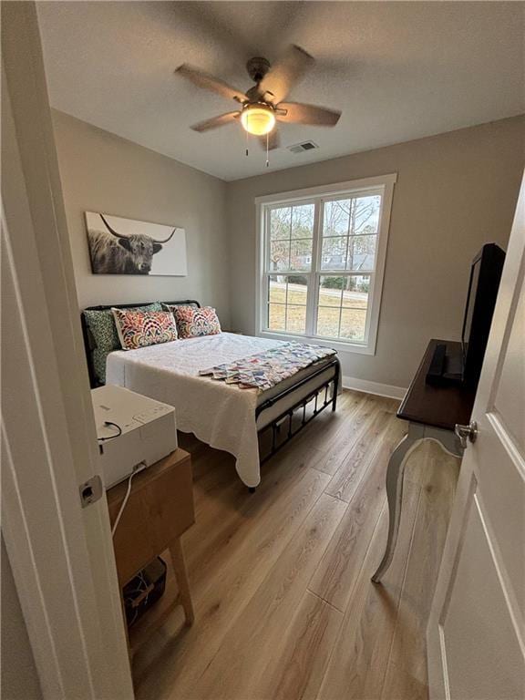 bedroom featuring ceiling fan and light hardwood / wood-style flooring