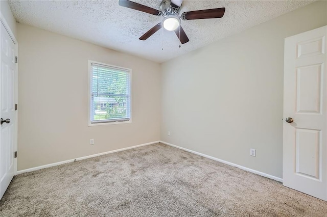 carpeted empty room featuring a textured ceiling and ceiling fan