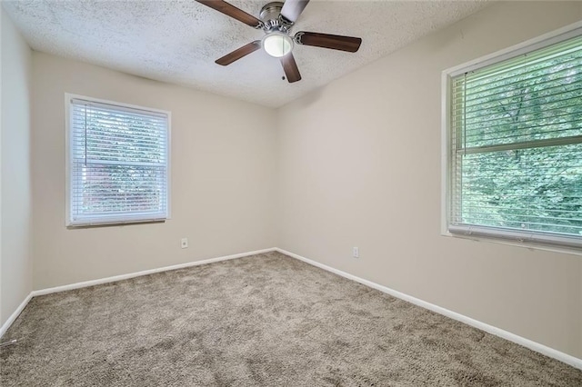 carpeted empty room featuring a textured ceiling and ceiling fan