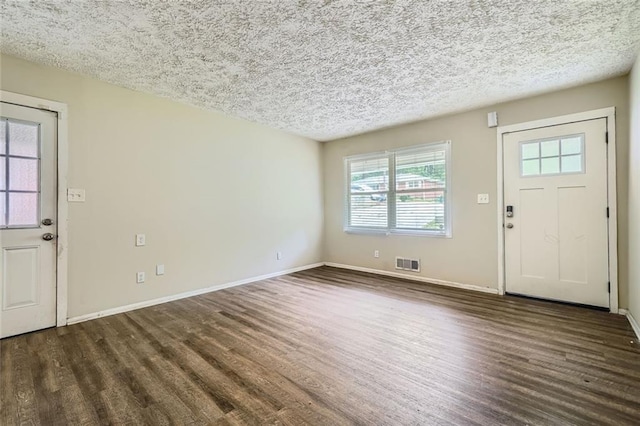 entrance foyer featuring dark hardwood / wood-style floors and a textured ceiling