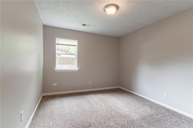 1615 Enchanted Forest Dr, Conley, GA 30288 - spare room featuring baseboards, carpet flooring, a textured ceiling, and visible vents