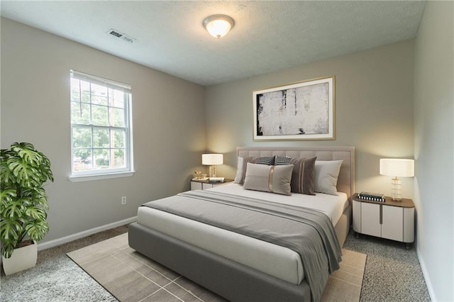 1615 Enchanted Forest Dr, Conley, GA 30288 - bedroom with baseboards, carpet, a textured ceiling, and visible vents
