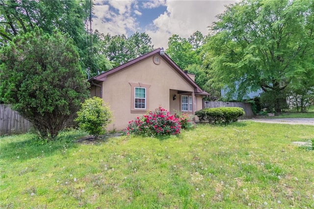 1615 Enchanted Forest Dr, Conley, GA 30288 - view of front facade with fence, a front lawn, and stucco siding
