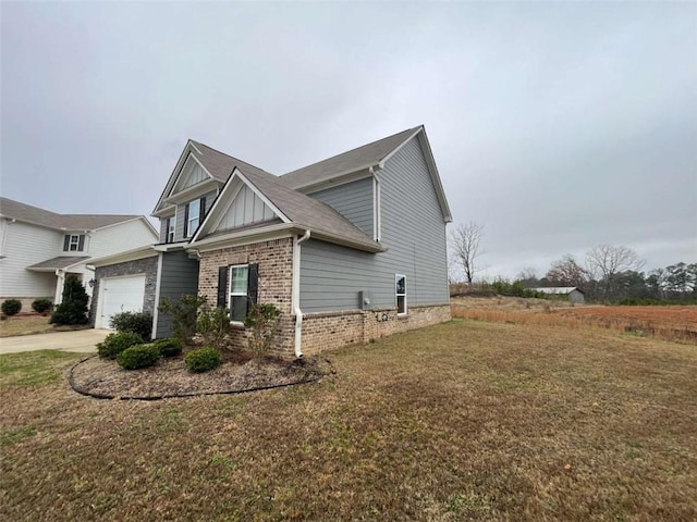 view of home's exterior with a lawn and a garage