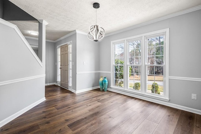 unfurnished dining area featuring dark wood-type flooring, baseboards, and a chandelier