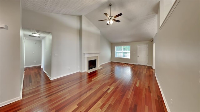 unfurnished living room with wood-type flooring, a textured ceiling, high vaulted ceiling, and ceiling fan