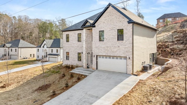 view of front of property with central AC and a garage