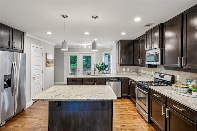 1735 Jobeth Ave SE, Atlanta, GA 30316 - kitchen featuring appliances with stainless steel finishes, crown molding, tasteful backsplash, dark brown cabinetry, and light wood-type flooring
