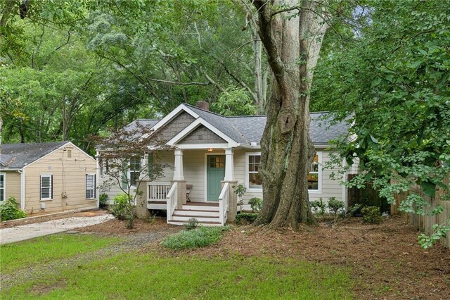 1735 Jobeth Ave SE, Atlanta, GA 30316 - view of front facade featuring a porch, a chimney, and a shingled roof